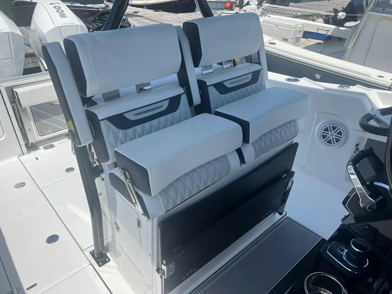 Slide: The Image of 2023 Blackfin 302 CC boat with open storage compartment at dock. - 17