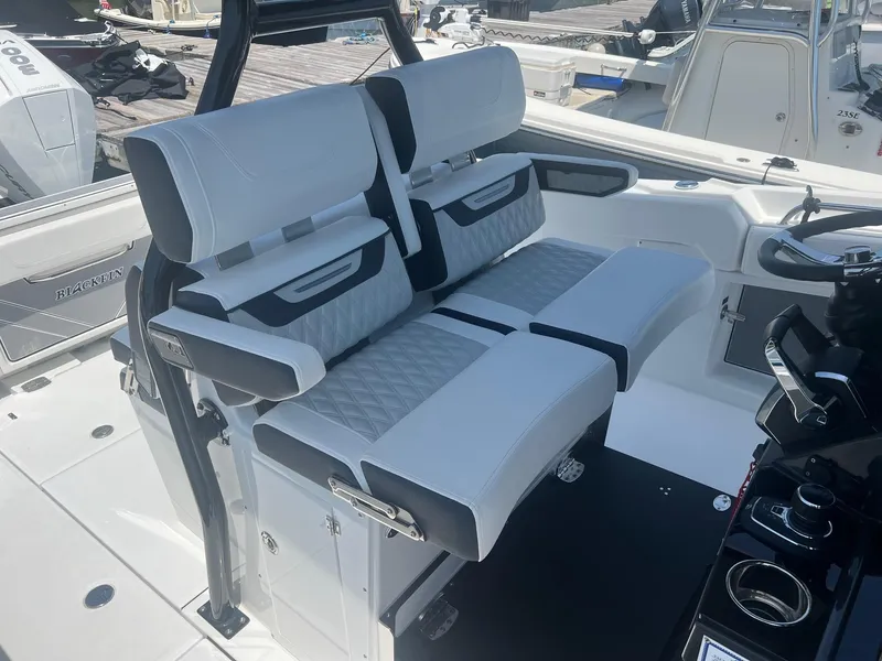 Slide: The Image of 2023 Blackfin 302 CC boat helm with dual Garmin displays and Mercury controls. - 18