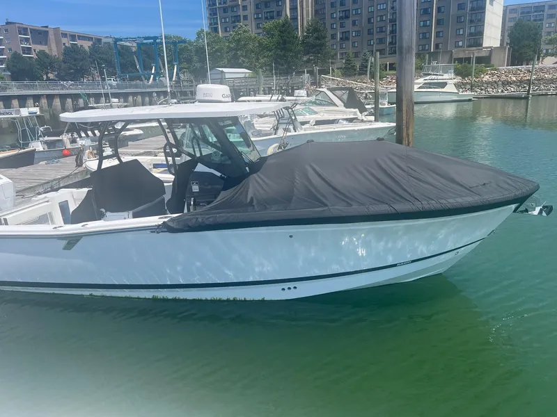 Slide: The Image of 2023 Blackfin 302 CC boat docked at marina with twin engines. - 2
