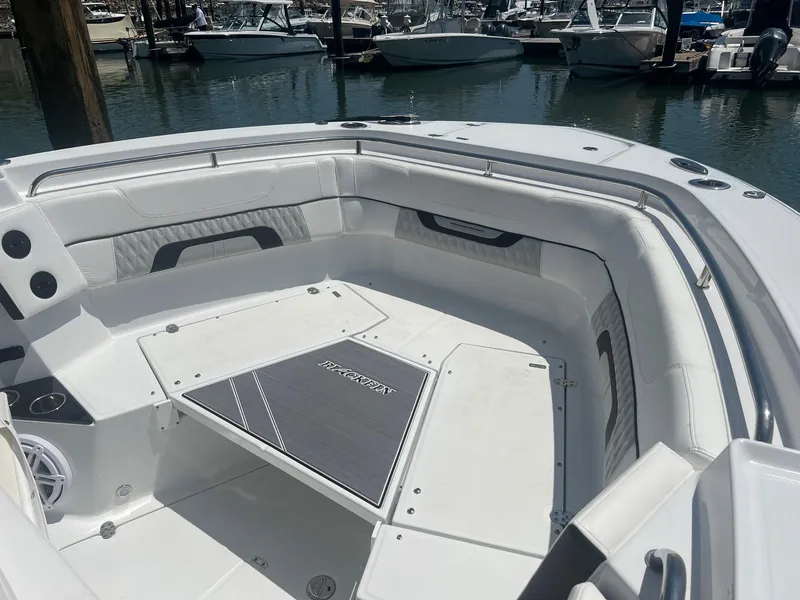 Slide: The Image of 2023 Blackfin 302 CC boat interior with rod holders and speakers. - 27