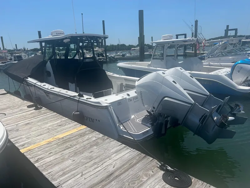 Slide: The Image of 2023 Blackfin 302 CC boat docked in a marina. - 4