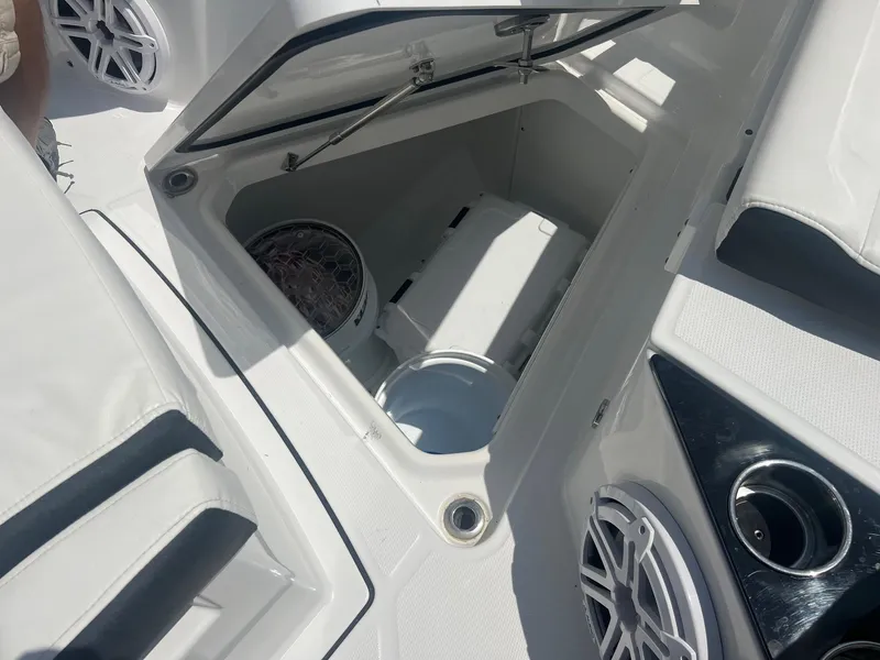 Slide: The Image of 2023 Blackfin 302 CC boat docked at a marina with twin outboard engines. - 6