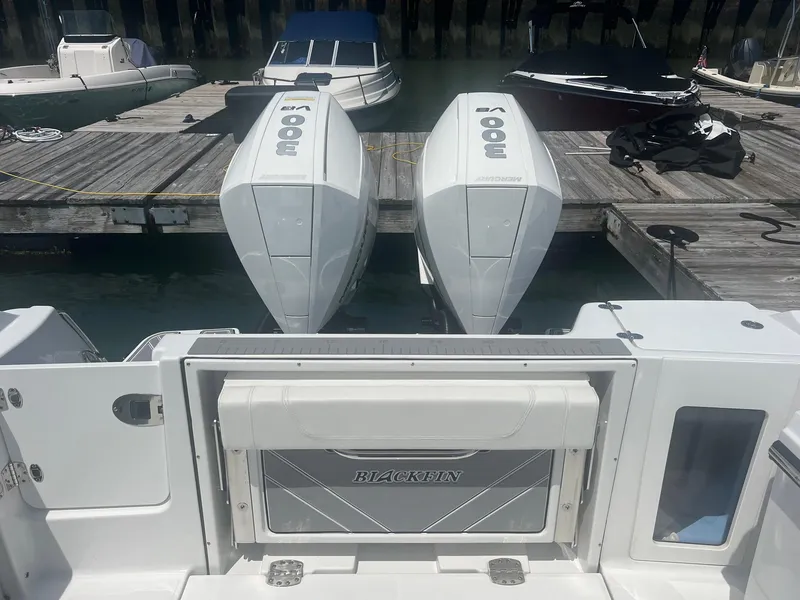 Slide: The Image of 2023 Blackfin 302 CC boat docked at a marina. - 7
