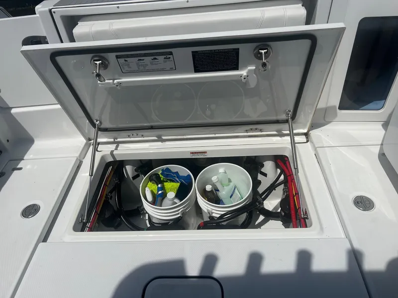 Slide: The Image of 2023 Blackfin 302 CC boat interior with white cushioned seating and modern amenities. - 8