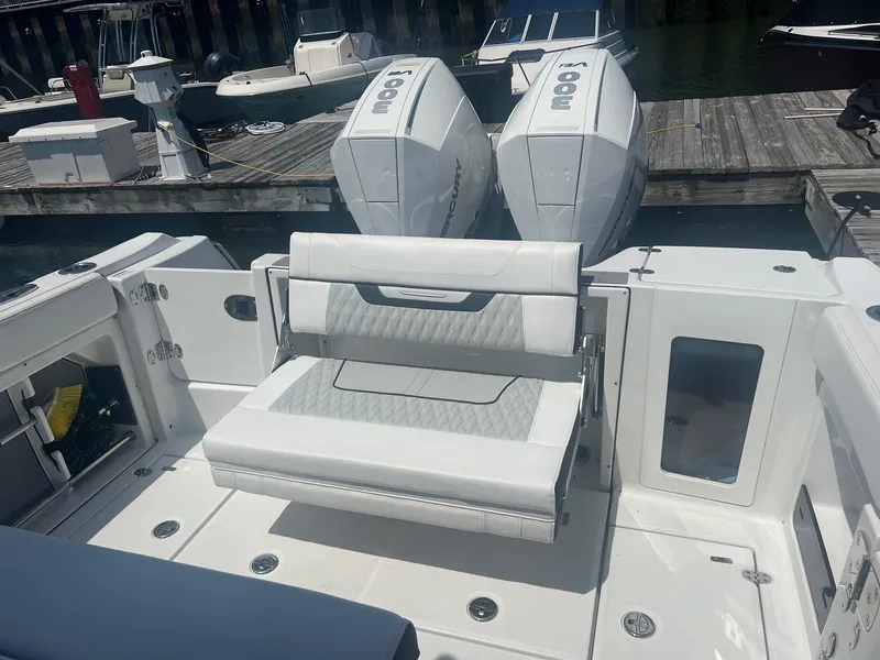 Slide: The Image of 2023 Blackfin 302 CC boat storage compartment with open hatch and speakers. - 9