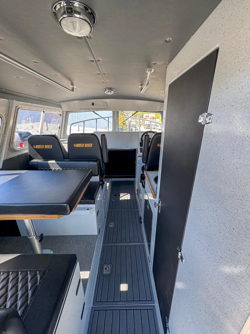Slide: The Image of Interior of 2024 North River Seahawk OS 2700SXL boat with seating and table. - 4