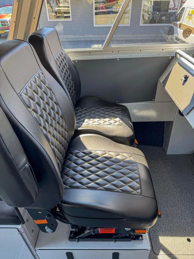 Slide: The Image of 2024 North River Seahawk OS 2700SXL interior with black diamond-stitched seats. - 6