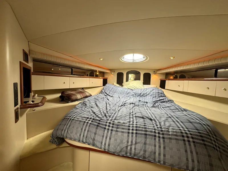 Slide: The Image of 1999 Cruisers Yachts 4270 Esprit cabin with bed and storage cabinets. - 14