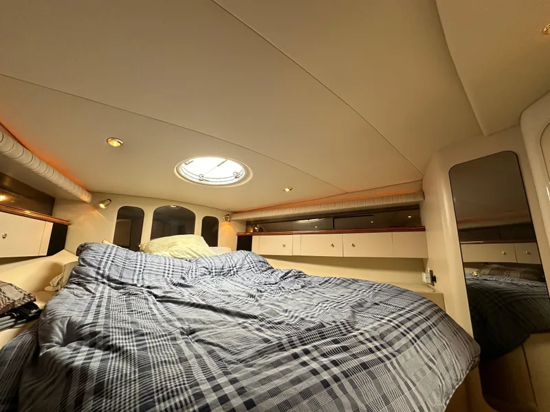 Slide: The Image of 1999 Cruisers Yachts 4270 Esprit cabin with bed and storage compartments. - 15