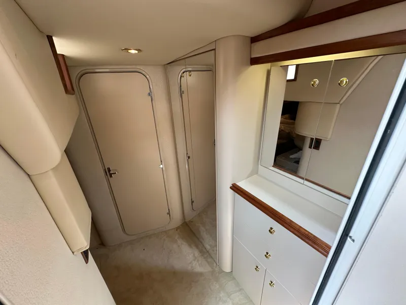 Slide: The Image of 1999 Cruisers Yachts 4270 Esprit interior cabin with storage and mirror. - 17
