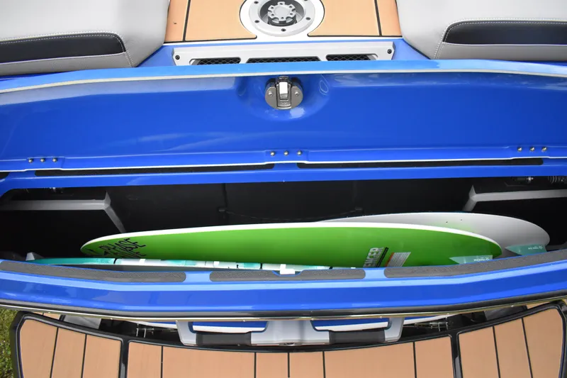 Slide: The Image of 2024 Supra SV boat with open storage compartment holding surfboards. - 7
