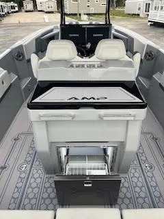 Slide: The Image of 2025 AMP 333CC boat interior with seating and storage compartments. - 12