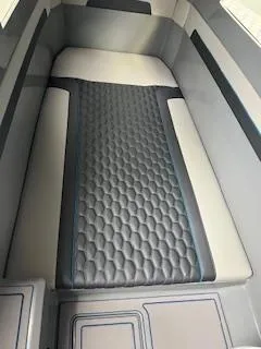 Slide: The Image of Interior of 2025 AMP 333CC boat with cushioned seating and modern design. - 16