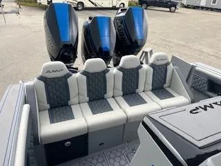 Slide: The Image of 2025 AMP 333CC boat with triple outboard engines and luxury seating. - 20