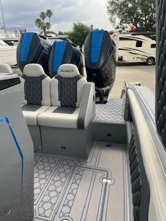 Slide: The Image of 2025 AMP 333CC boat with dual outboard engines and luxury seating. - 21