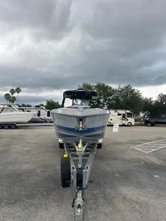 Slide: The Image of 2025 AMP 333CC boat on trailer under cloudy sky. - 3