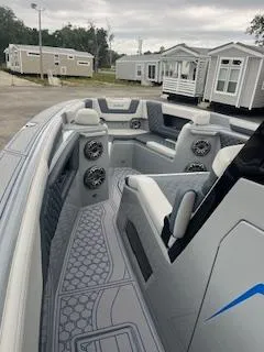 Slide: The Image of 2025 AMP 333CC boat interior with modern seating and speakers. - 6