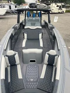 Slide: The Image of 2025 AMP 333CC boat with modern seating and sleek design. - 7