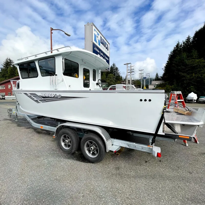 Slide: The Image of 2024 Hewescraft 240 Pacific Cruiser on a trailer in a parking lot. - 2