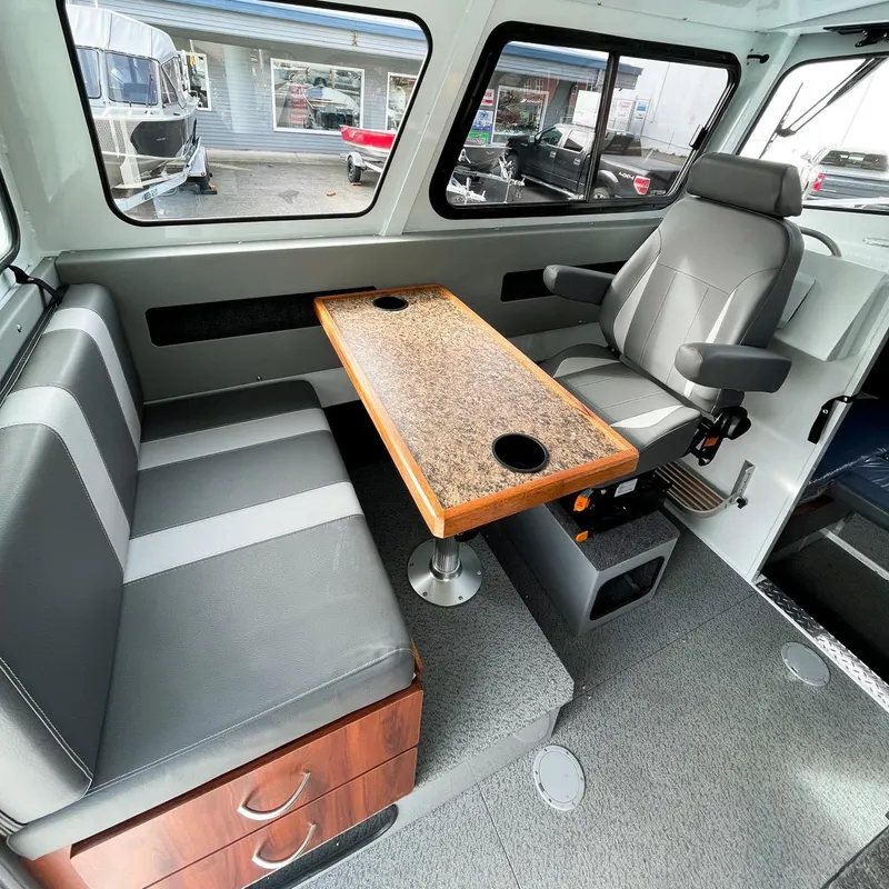 Slide: The Image of Interior of 2024 Hewescraft 240 Pacific Cruiser with seating and table. - 6