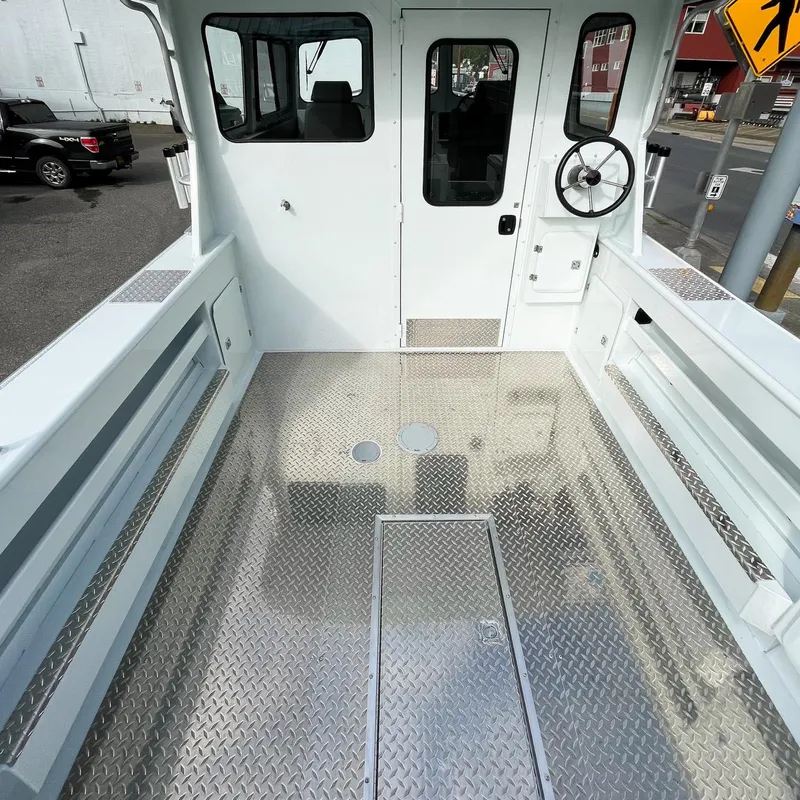 Slide: The Image of 2024 Hewescraft 240 Pacific Cruiser boat interior with diamond plate flooring. - 9