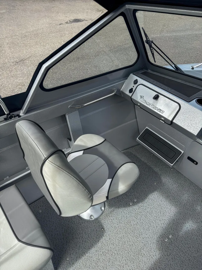 Slide: The Image of 2024 KingFisher 1825 Falcon boat interior with captain's chair and dashboard. - 4