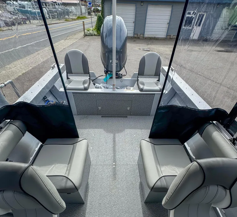Slide: The Image of 2024 KingFisher 1825 Falcon boat interior with seating and outboard motor. - 5