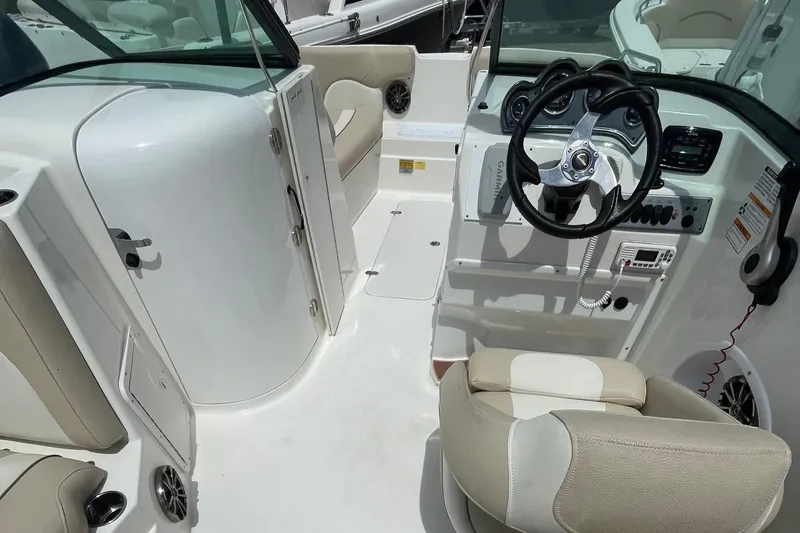 Slide: The Image of 2018 NauticStar 223DC Sport Deck boat interior with steering wheel and seating. - 10