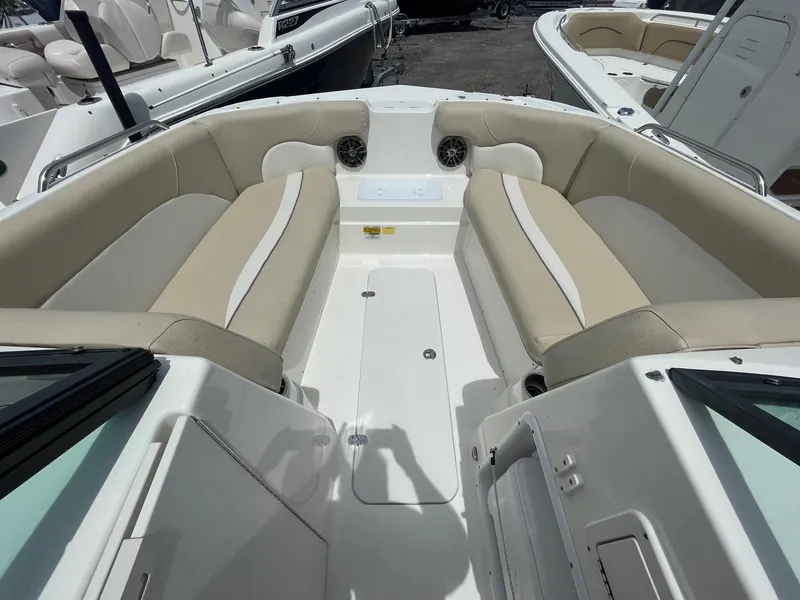 Slide: The Image of 2018 NauticStar 223DC Sport Deck boat interior with beige and white seating. - 6