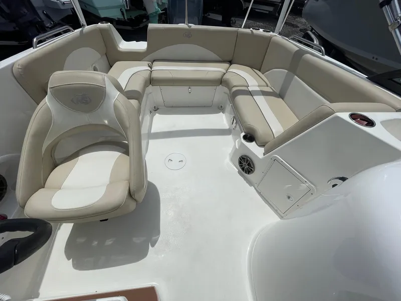 Slide: The Image of 2018 NauticStar 223DC Sport Deck interior with beige seating and white deck. - 7