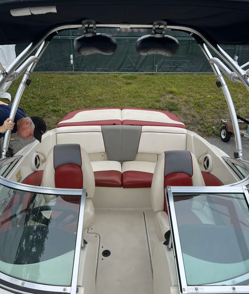 Slide: The Image of 2007 Sea Ray 185 Sport boat interior with red and gray seating, open windshield, and wakeboard tower. - 5