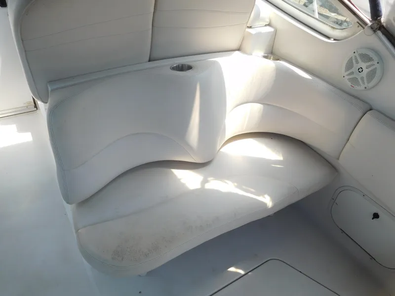 Slide: The Image of 2001 Four Winns 298 Vista boat interior seating area with cup holder. - 11