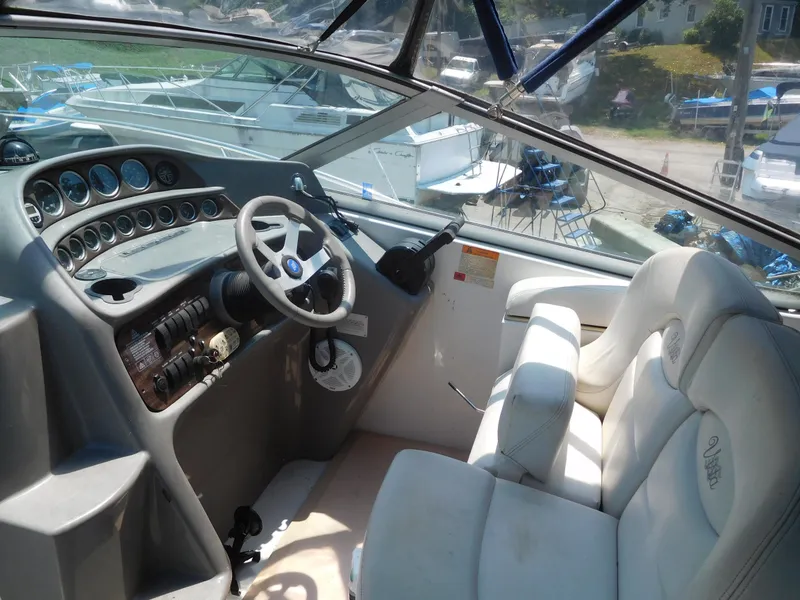 Slide: The Image of 2001 Four Winns 298 Vista boat cockpit with steering wheel and control panel. - 14