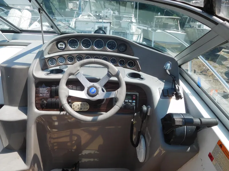 Slide: The Image of 2001 Four Winns 298 Vista boat helm with steering wheel and instrument panel. - 15