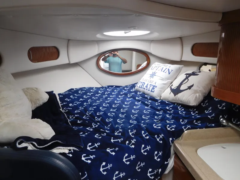 Slide: The Image of 2001 Four Winns 298 Vista cabin with nautical-themed bedding and cozy interior. - 19