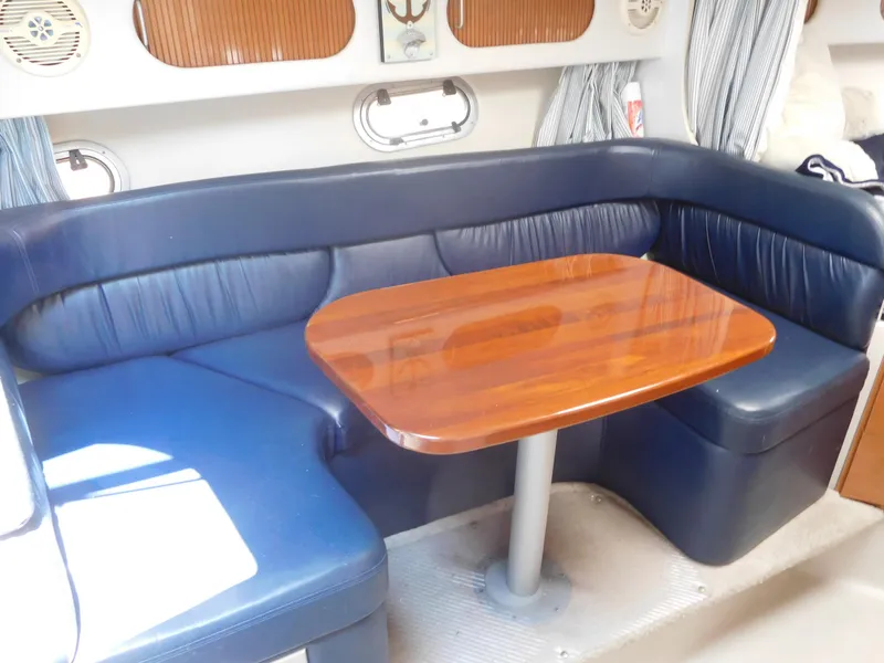 Slide: The Image of 2001 Four Winns 298 Vista cabin with blue leather seating and wooden table. - 20