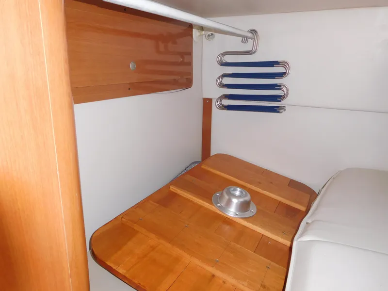 Slide: The Image of 2001 Four Winns 298 Vista cabin interior with wooden table and seating area. - 26