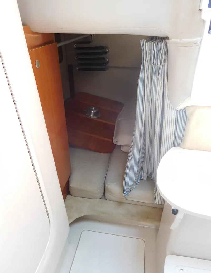 Slide: The Image of 2001 Four Winns 298 Vista cabin interior with seating and striped curtain. - 31