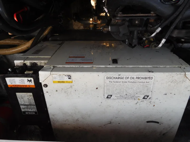 Slide: The Image of Engine compartment of a 2001 Four Winns 298 Vista boat with oil discharge warning. - 36