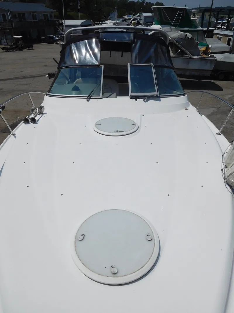 Slide: The Image of 2001 Four Winns 298 Vista boat docked, front deck view with hatches and windshield. - 4