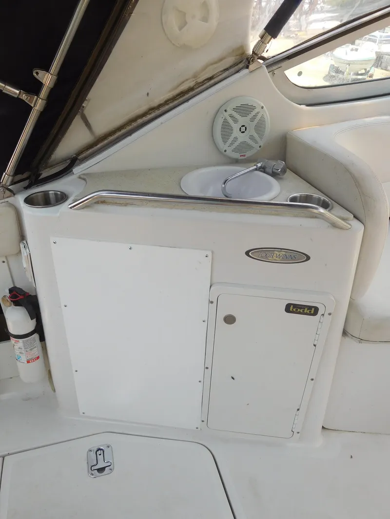 Slide: The Image of 2001 Four Winns 298 Vista boat interior with sink and storage compartments. - 6
