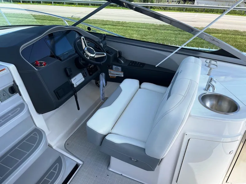 Slide: The Image of 2025 Regal 33 Express boat cockpit with modern helm and seating. - 6