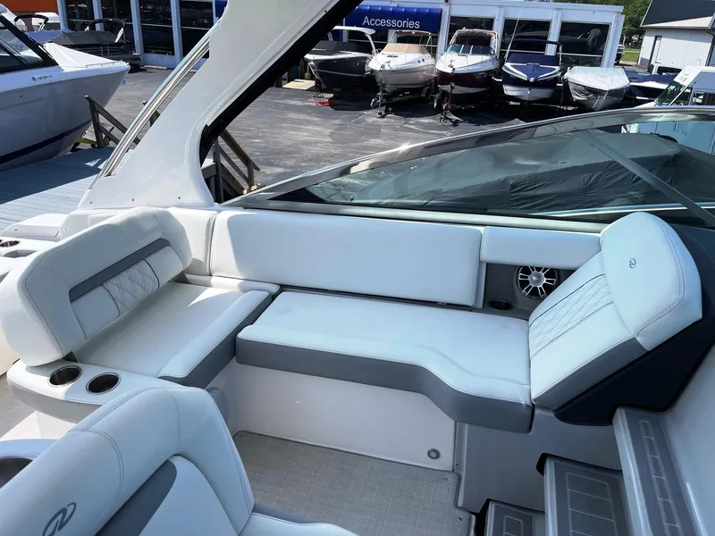 Slide: The Image of 2025 Regal 33 Express boat interior with white and gray seating. - 7