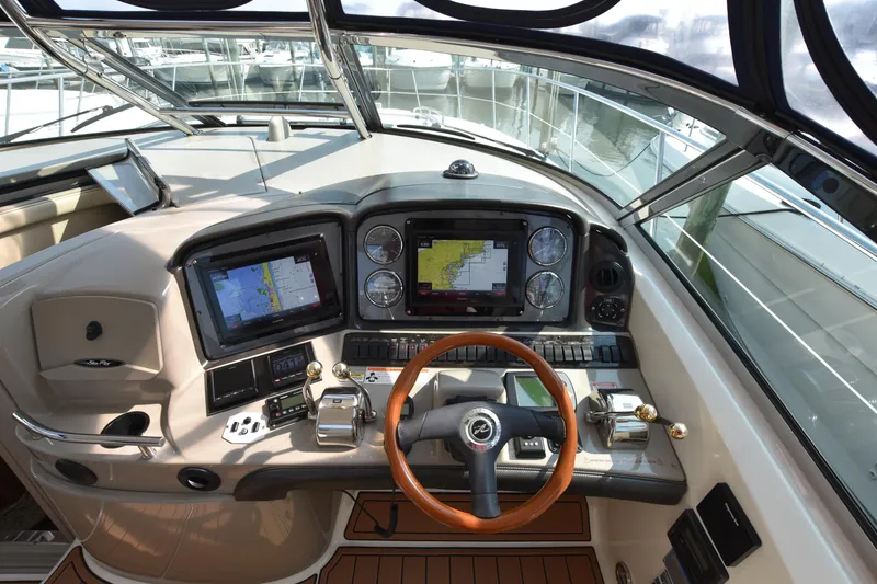 Slide: The Image of Helm of 2006 Sea Ray 40 Sundancer with navigation screens and controls. - 16