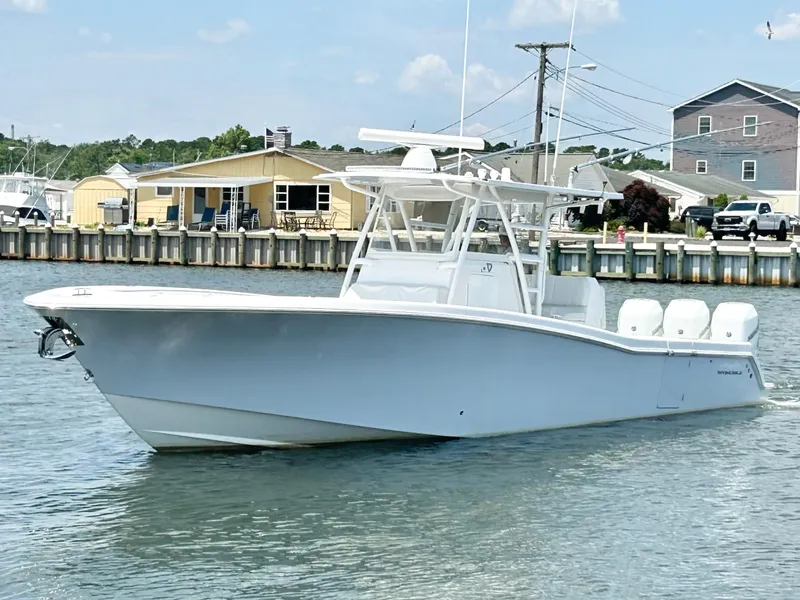 Slide: The Image of 2018 Invincible 36 Open boat cruising in a marina. - 0