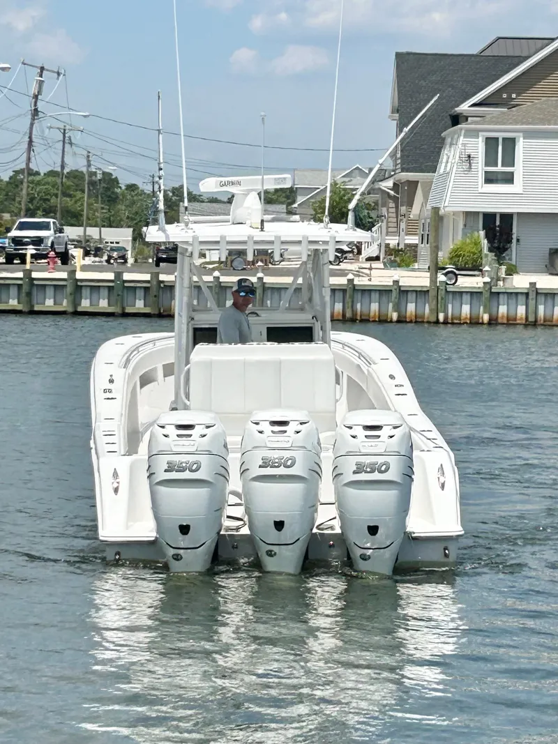 Slide: The Image of 2018 Invincible 36 Open boat with triple outboard engines on the water. - 5