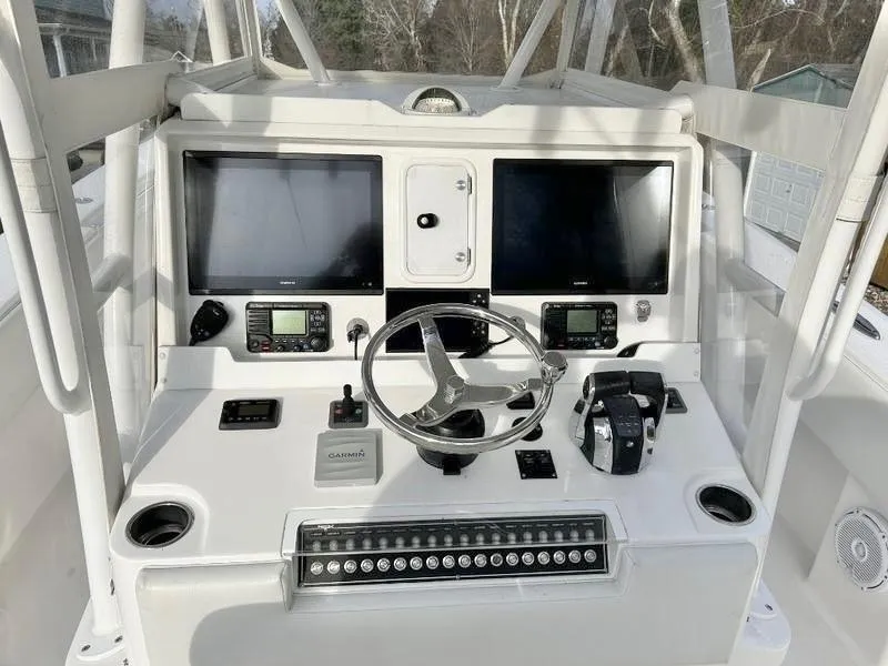 Slide: The Image of 2018 Invincible 36 Open boat helm with dual screens and navigation controls. - 6