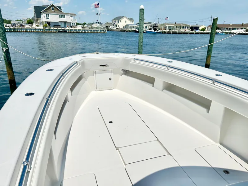 Slide: The Image of 2018 Invincible 36 Open boat docked in a scenic waterfront marina. - 7