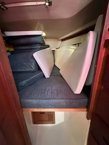 Slide: The Image of Interior cabin of 1983 Catalina 30 Tall Rig with stacked cushions. - 10