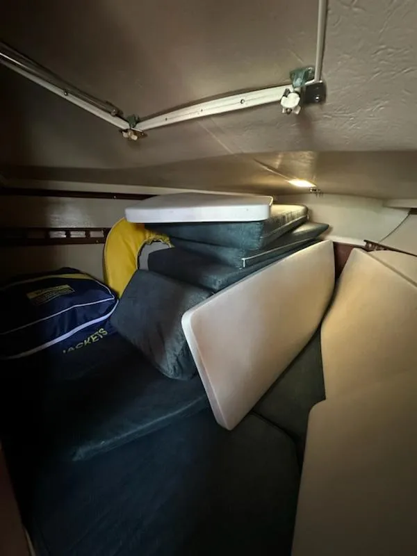 Slide: The Image of Interior storage area of a 1983 Catalina 30 Tall Rig sailboat with cushions and gear. - 14